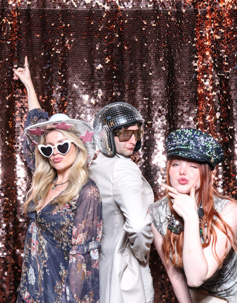 3 guests using props while posing for photobooths for events during a party entertainment 