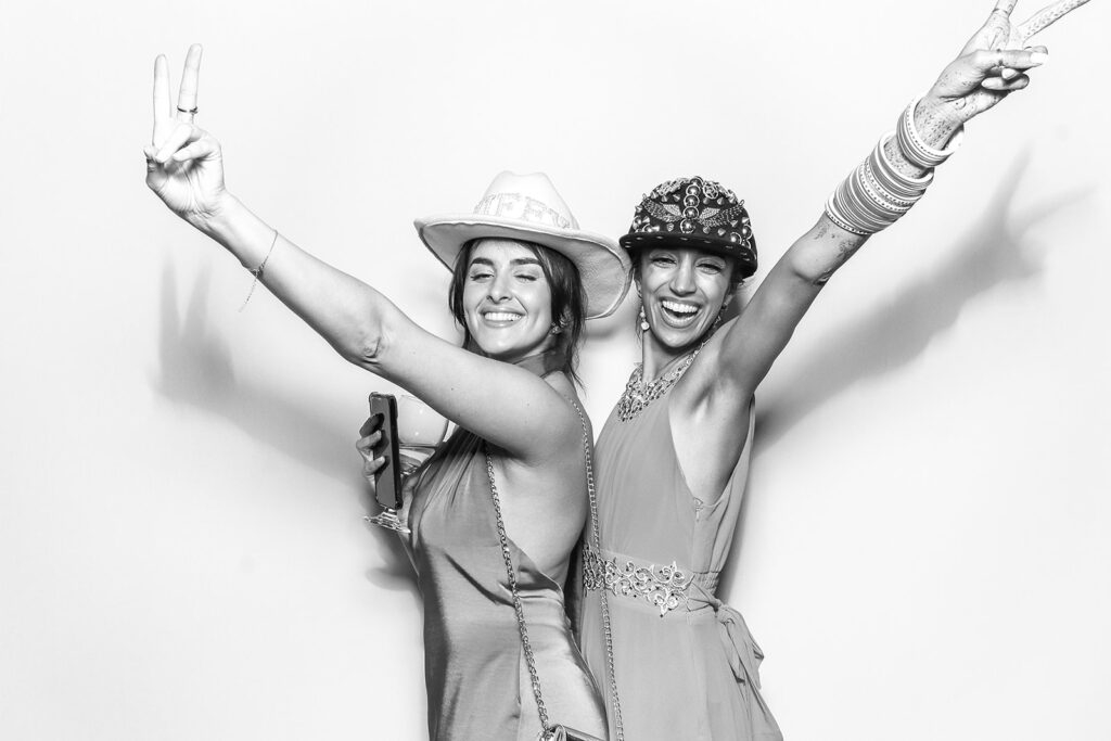 2 ladies posing against a white backdrop with a b&w filter for a De Vere Tortworth Court Wedding