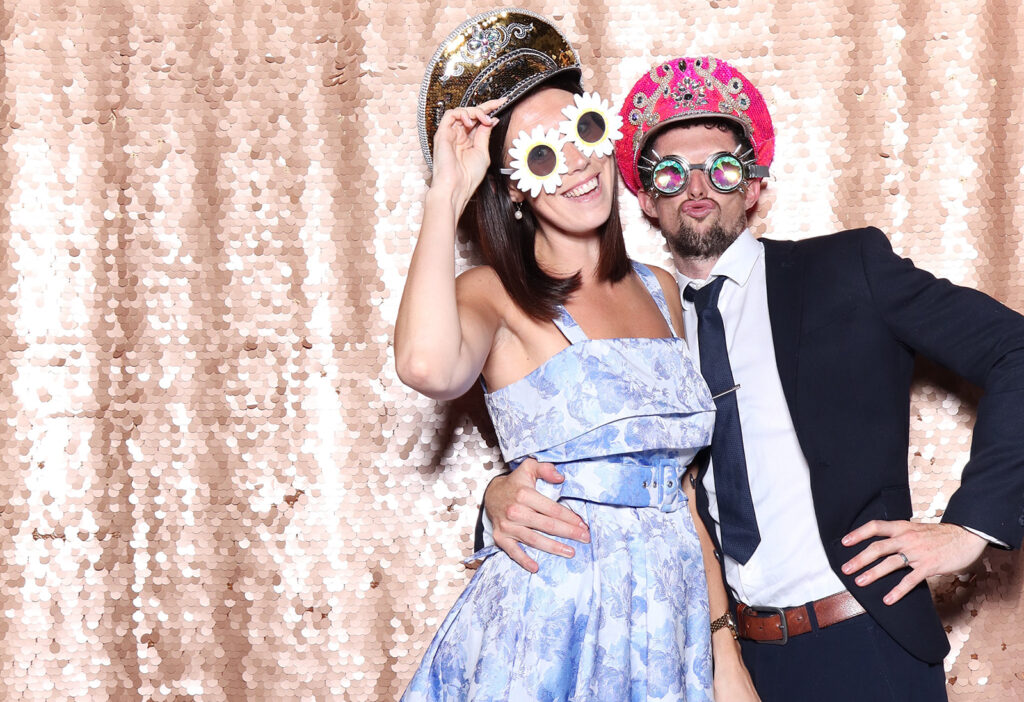 couple posing with fancy props for a De Vere Tortworth Court Wedding party entertainment  in the cotswolds
