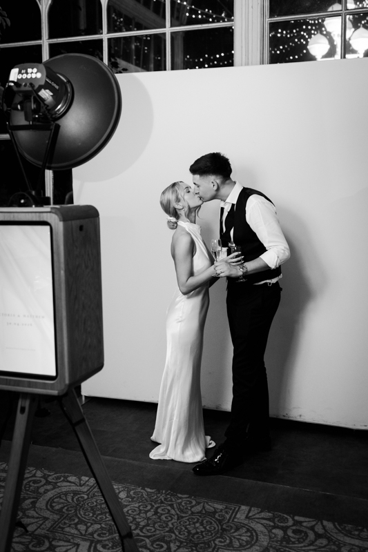 wooden photo booth setup with flash in the orangery at De Vere Tortworth Court party
