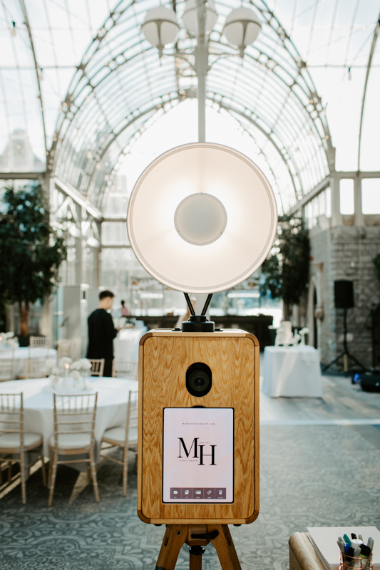 wooden photo booth setup with flash in the orangery at De Vere Tortworth Court party
