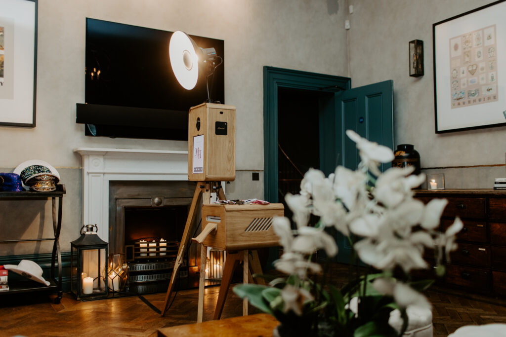 beautiful wooden photo booth setup with the icon, a premium photo booth hire in cheltenham for an 18th birthday party at no131

