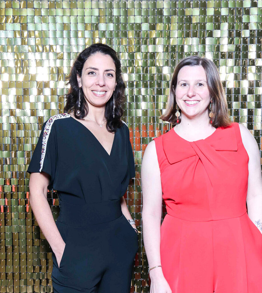 Luxury Corporate Photo Booth Rental in Oxfordshire with guests posing against a gold shimmer backdrop during an awards dinner