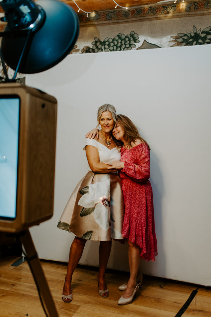 Guests using the photo booth at an Owlpen Manor wedding