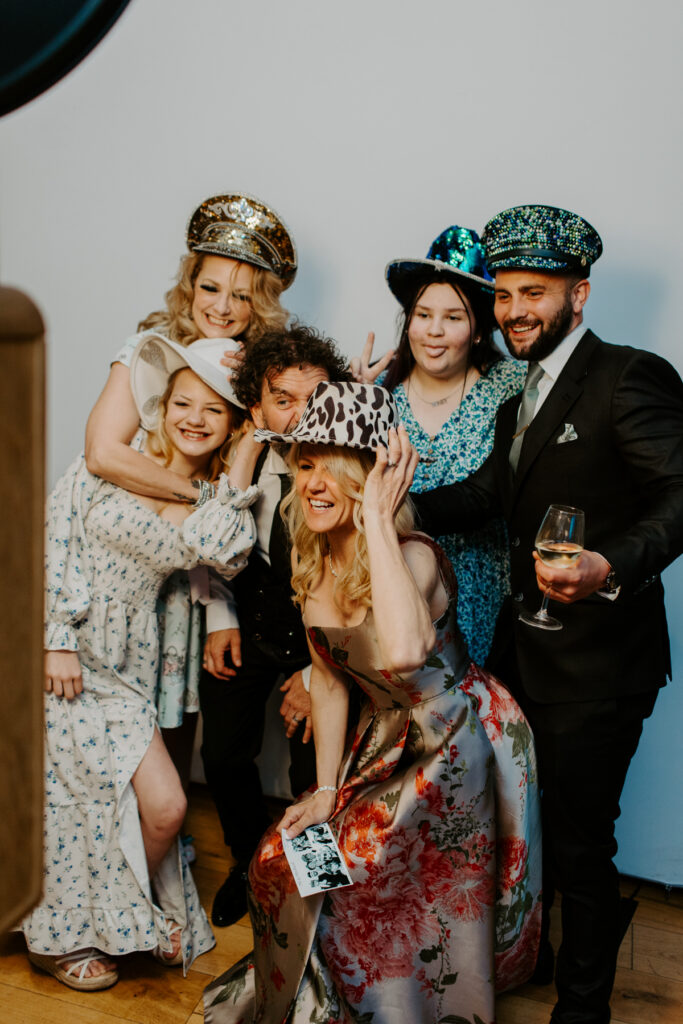 Guests smiling in the photo booth at Owlpen Manor