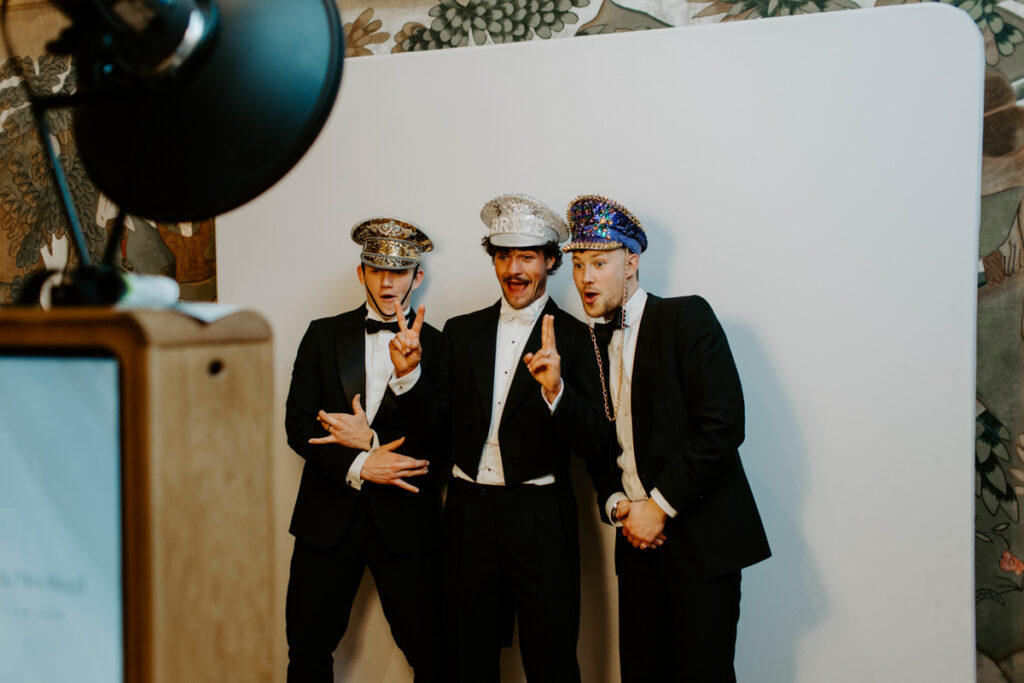 Guests using the photo booth at an Owlpen Manor wedding

