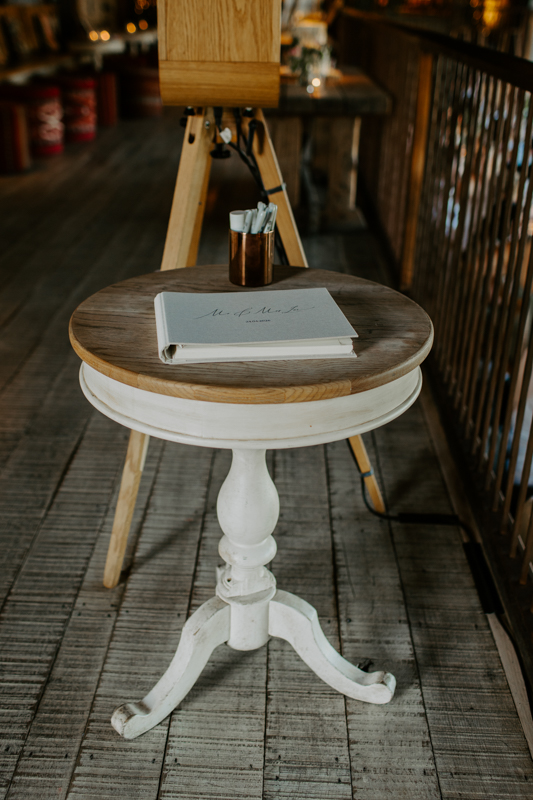 Photo booth guest book station with prints, pens and keepsake album
