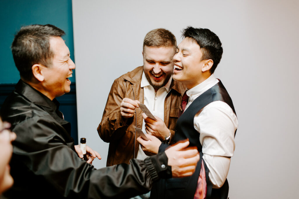 guests checking prints during an Oxford Town Hall event entertainment for Corporate Events with the icon premium photo booth hire for Kibou restaurant team party 
