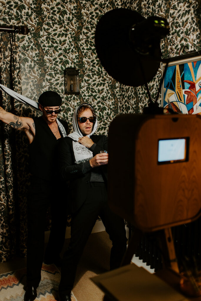 boys posing for a retro photo booth hire and custom guest book during a private party at coombe end manor in cheltenham