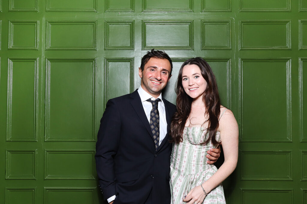 couple posing the green wall at dumbleton hall wedding venue
